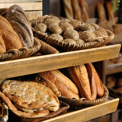 Assortment of baked bread on shelves.