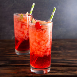 Glass of Cold Refreshing Cherry Limeade on a Wooden Table
