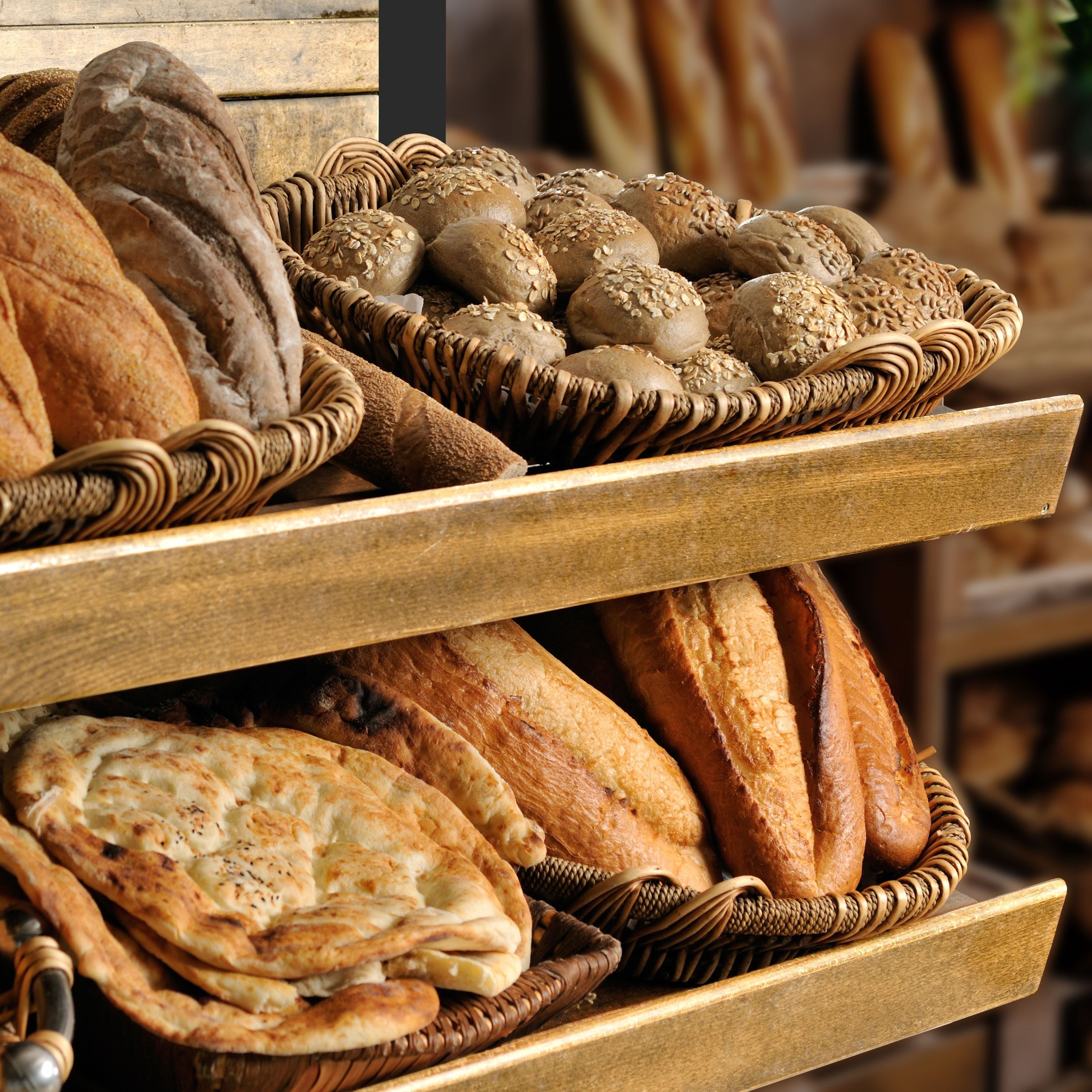 Assortment of baked bread on shelves.